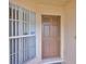 Inviting front entrance with a beige door, sidelight, and a clear view of the house number at 1005 Hardwood Dr, Valrico, FL 33596