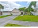 Charming single-story home featuring a two-car garage and lush green lawn at 1005 Hardwood Dr, Valrico, FL 33596