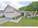 Lovely home featuring a well-manicured lawn, mature landscaping, and a welcoming entrance at 1005 Hardwood Dr, Valrico, FL 33596