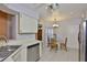 Corner of bright kitchen with stainless steel appliances, white cabinets, and dining nook at 1005 Hardwood Dr, Valrico, FL 33596