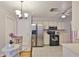 Bright eat-in kitchen featuring stainless steel appliances and a glass top dining table at 1005 Hardwood Dr, Valrico, FL 33596