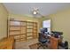 Office featuring a desk, chair, large bookshelves, and a window at 1005 Hardwood Dr, Valrico, FL 33596