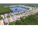 Aerial view of homes in a community around a lake, surrounded by lush trees and vegetation at 1015 Seagrape Dr, Ruskin, FL 33570