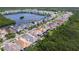Overhead view of homes along a lake highlighting serene waterfront living with community docks and manicured lawns at 1015 Seagrape Dr, Ruskin, FL 33570