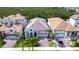 Aerial view of a home featuring a tile roof, manicured lawn, and a three-car garage at 1015 Seagrape Dr, Ruskin, FL 33570