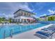 Beautiful two-story clubhouse overlooking a sparkling pool with plenty of lounge chairs and outdoor space at 1015 Seagrape Dr, Ruskin, FL 33570