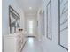 Bright hallway with modern decor, featuring light-colored walls, decorative art, and a decorative front door at 1015 Seagrape Dr, Ruskin, FL 33570
