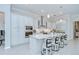 Gourmet kitchen featuring white cabinetry, stainless steel appliances, a large center island, and modern pendant lighting at 1015 Seagrape Dr, Ruskin, FL 33570