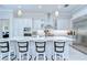 Elegant kitchen boasts white cabinets, stainless steel appliances, granite countertops, and bar seating, perfect for entertaining at 1015 Seagrape Dr, Ruskin, FL 33570