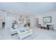 Open-concept living space showcasing neutral tones, modern furnishings, and seamless flow into the dining area and kitchen at 1015 Seagrape Dr, Ruskin, FL 33570