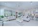 Airy living room featuring two couches, light colored wood floors and a view of the green backyard at 1015 Seagrape Dr, Ruskin, FL 33570