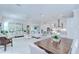 Bright, open-concept living room flows into a modern kitchen with stainless steel appliances and light wood flooring at 1015 Seagrape Dr, Ruskin, FL 33570