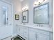 A bright bathroom with double sinks and a large mirror at 1015 Seagrape Dr, Ruskin, FL 33570