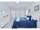 Bright primary bedroom with a large bed, white furniture, and natural light from multiple windows at 1015 Seagrape Dr, Ruskin, FL 33570
