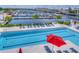 Inviting pool area with ample lounge chairs, a red umbrella, and a view of the marina and surrounding community at 1015 Seagrape Dr, Ruskin, FL 33570