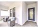 Inviting front porch features comfortable seating with stylish chairs and a view of the home's entry at 1015 Seagrape Dr, Ruskin, FL 33570