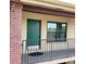 A close-up view of unit 222's entrance with a green door, window, and black railing at 1020 85Th N Ave # 222, St Petersburg, FL 33702