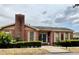 Charming brick building with a chimney and manicured landscaping provides a welcoming entrance at 1020 85Th N Ave # 222, St Petersburg, FL 33702