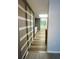 Hallway with built-in storage, leading to a kitchen with skylight and lots of windows at 1020 85Th N Ave # 222, St Petersburg, FL 33702