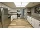 Modern kitchen with white cabinets, stainless steel appliances, and a skylight at 1020 85Th N Ave # 222, St Petersburg, FL 33702