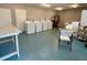 Bright laundry room featuring multiple washing machines, folding table, and ample space at 1020 85Th N Ave # 222, St Petersburg, FL 33702