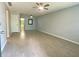 Bright living room featuring wood-look tile flooring, ceiling fans, and neutral paint at 1020 85Th N Ave # 222, St Petersburg, FL 33702