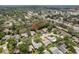 Aerial perspective of a neighborhood with houses nestled among trees, close to roads at 10516 Mira Vista Dr, Port Richey, FL 34668