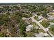 An aerial view shows homes in a verdant neighborhood with mature trees at 10516 Mira Vista Dr, Port Richey, FL 34668