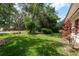 Backyard with lush green grass and lots of trees providing ample shade at 10516 Mira Vista Dr, Port Richey, FL 34668