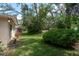Beautiful backyard featuring lush green grass, various shade trees, and well maintained landscaping at 10516 Mira Vista Dr, Port Richey, FL 34668