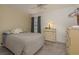 Cozy bedroom with carpet, a large window, neutral wall color, chest of drawers and ceiling fan at 10516 Mira Vista Dr, Port Richey, FL 34668