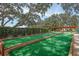 Scenic bocce ball court, with trees, a sitting area, and shade at 10516 Mira Vista Dr, Port Richey, FL 34668