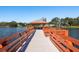 Picturesque lake pier with covered gazebo seating offers serene waterfront views at 10516 Mira Vista Dr, Port Richey, FL 34668