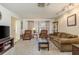 Comfortable living room featuring neutral carpeting, recessed lighting, and a cozy seating area with a large window at 10516 Mira Vista Dr, Port Richey, FL 34668