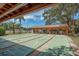 Multiple shuffleboard courts with covered seating, and a glimpse of the lake at 10516 Mira Vista Dr, Port Richey, FL 34668