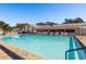 Community pool with clear blue water and ample seating, perfect for relaxation at 10516 Mira Vista Dr, Port Richey, FL 34668