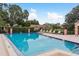 A sparkling community swimming pool surrounded by lounge chairs offers relaxation at 10516 Mira Vista Dr, Port Richey, FL 34668