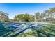 Well-maintained tennis courts surrounded by lush greenery and mature trees at 10516 Mira Vista Dr, Port Richey, FL 34668