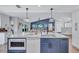 Open kitchen with a large island with seating, stainless steel appliances, and modern finishes at 10825 Christopher Ct, Largo, FL 33774