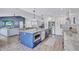 Spacious open kitchen featuring a large island, stainless appliances, and views of the living room at 10825 Christopher Ct, Largo, FL 33774
