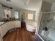 Bright bathroom showcasing double vanity sinks, a soaking tub, and a glass shower at 11312 Brussels Boy Ln, Riverview, FL 33578