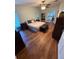 Spacious bedroom featuring wood-look flooring, neutral walls, ceiling fan, and French doors at 11312 Brussels Boy Ln, Riverview, FL 33578