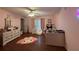 Pink bedroom with dresser, bed, and plenty of decor at 11312 Brussels Boy Ln, Riverview, FL 33578
