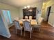 Dining room featuring hardwood floors, large china cabinet, and chandelier at 11312 Brussels Boy Ln, Riverview, FL 33578