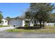 Charming single-story home with attached garage, well-maintained lawn, and mature trees providing shade at 11312 Brussels Boy Ln, Riverview, FL 33578