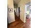 Hallway with wood-look flooring leading to the kitchen and other rooms at 11312 Brussels Boy Ln, Riverview, FL 33578