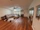 Comfortable living room featuring hardwood floors, sectional sofa, and ceiling fan at 11312 Brussels Boy Ln, Riverview, FL 33578