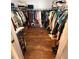 Large walk-in closet with wood-look flooring and ample storage space for clothes and shoes at 11312 Brussels Boy Ln, Riverview, FL 33578