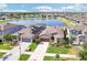 Expansive aerial view of the property with a lake view, solar panels, and a well manicured landscape at 11688 Brighton Knoll Loop, Riverview, FL 33579