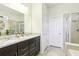 Elegant bathroom featuring double vanity sinks with granite countertops, perfect for a refreshing space at 11688 Brighton Knoll Loop, Riverview, FL 33579
